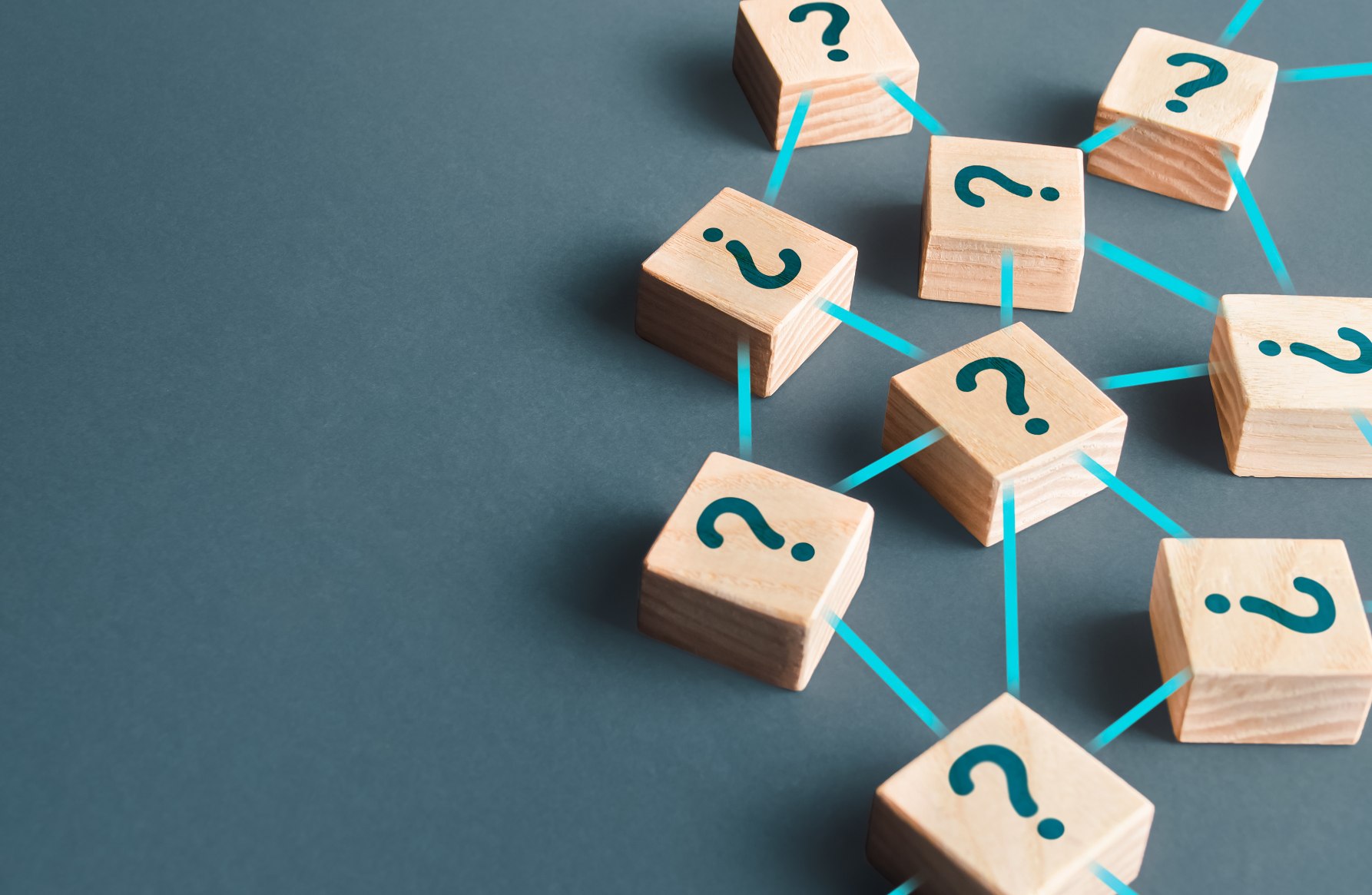solving problems for good small wooden cubes with question marks on them are connected by teal lines