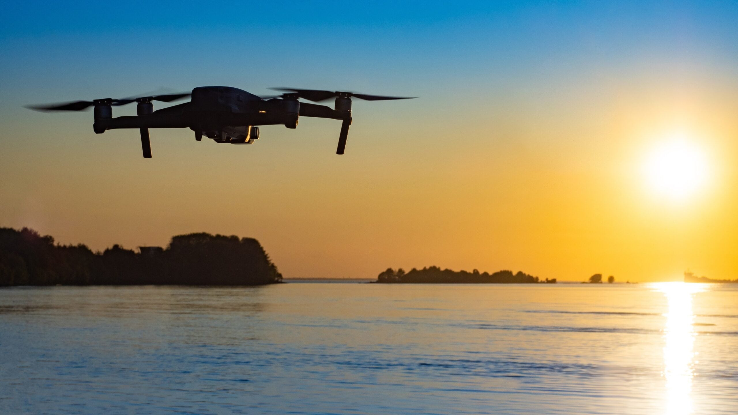 a drone hovers over the water
